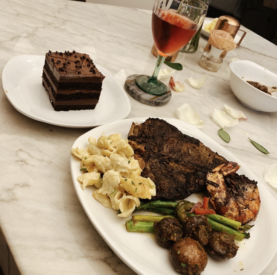 Steak and grilled seafood dinner with sides and dessert