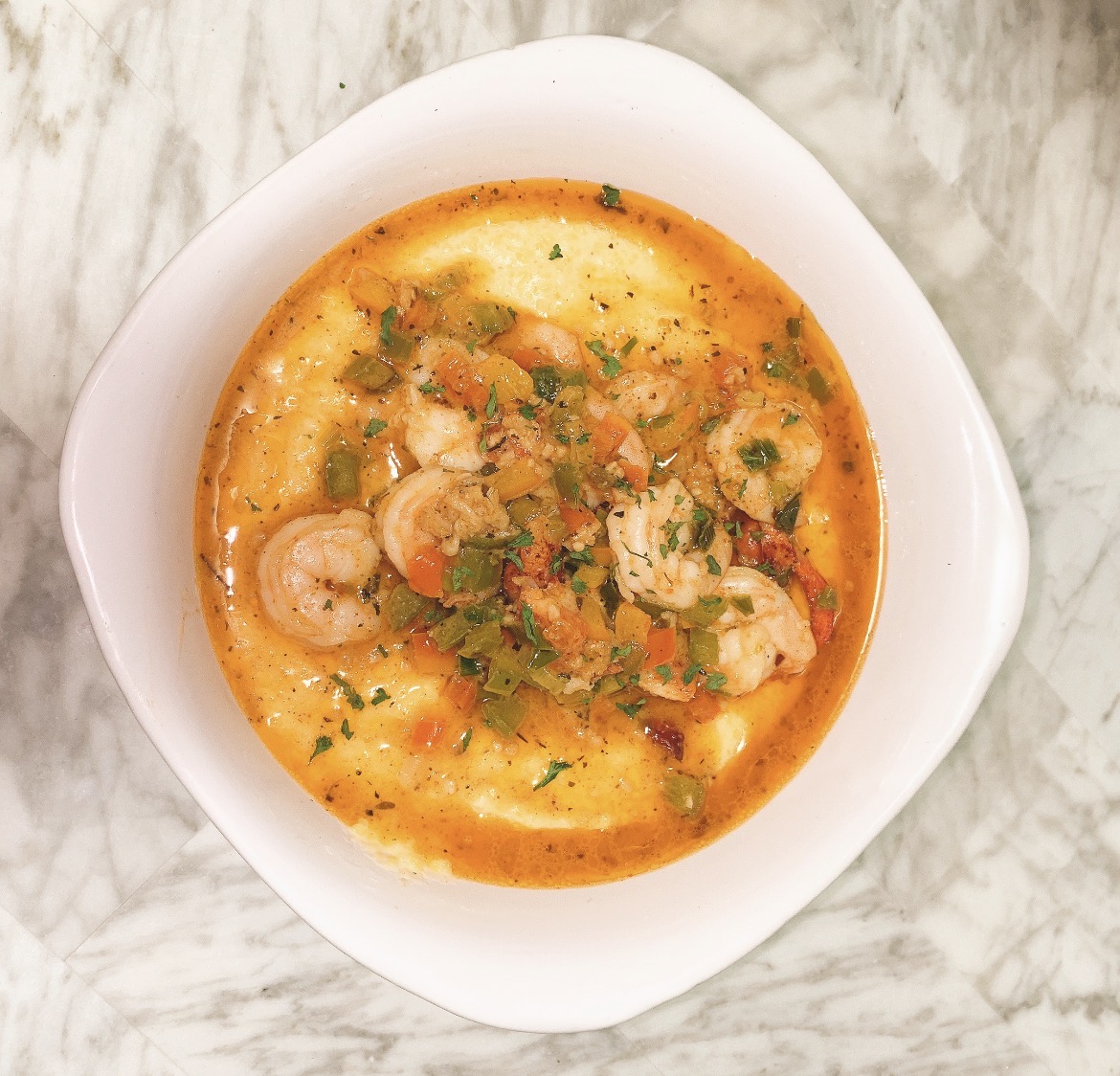Shrimp and grits with peppers and herbs